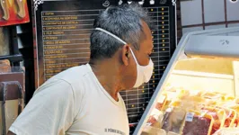 O autônomo Aluísio Brandão no setor de carnes do supermercado.