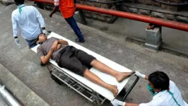 Profissionais de saúde evacua uma pessoa afetada pelo vazamento de gás na cidade indiana.