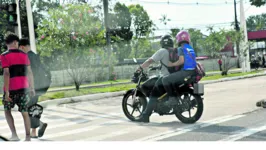 Flagrantes: moto disputa o espaço reservado aos pedestres. Abaixo, condutor trafega sem capacete