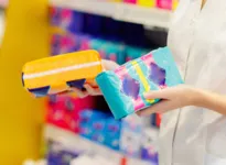 Sales clerk assisting customer choose from wide variety of sanitary pads