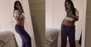 No vídeo, a atriz aparece de calça roxa e camiseta branca levantada, exibindo um abdômen definido de dar inveja