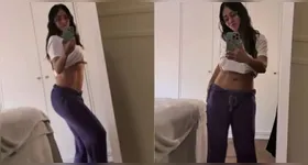 No vídeo, a atriz aparece de calça roxa e camiseta branca levantada, exibindo um abdômen definido de dar inveja