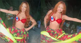 Ruivinha de Marte dança carimbó em Alter do Chão com figurino típico e bandeira do Pará no peito.