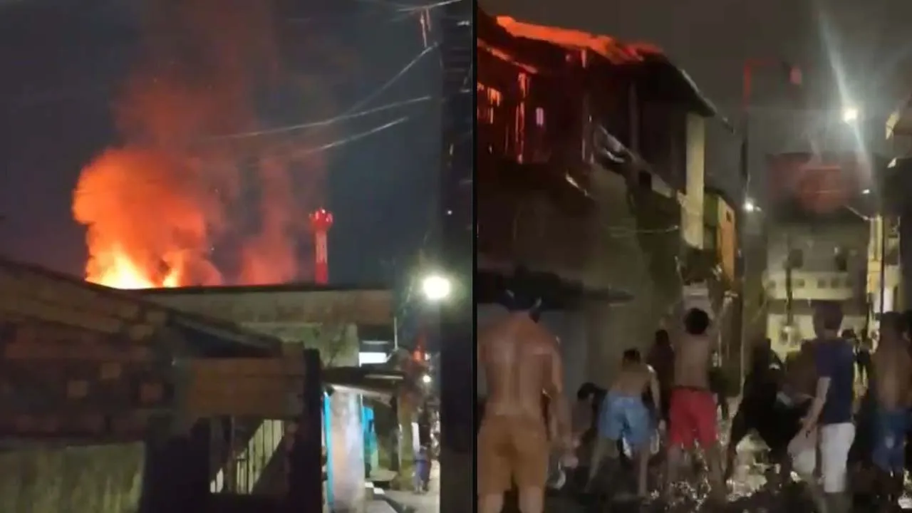 Casa atingida e moradores pegando água da vala para apagar