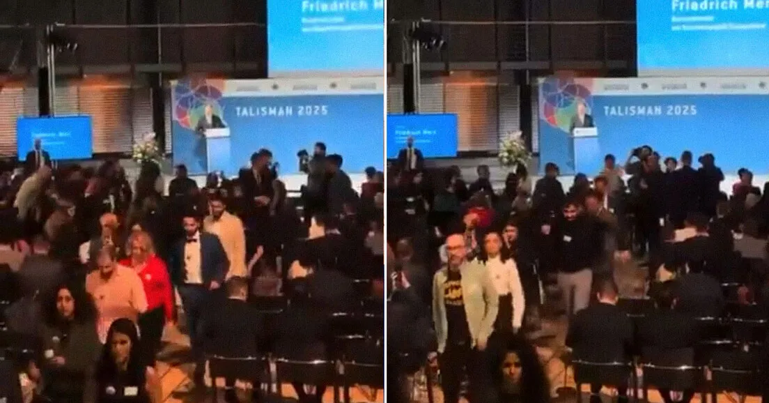 Momento em que convidados deixam o auditório em protesto durante o discurso do premiê alemão Friedrich Merz, após declarações polêmicas sobre migrantes e “paisagem urbana”.