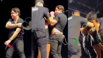 Seguranças tiveram que intervir para mulher soltar o cantor