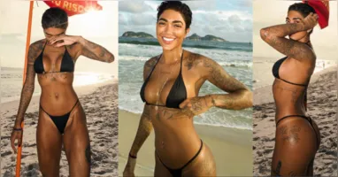Dhiovanna Barbosa rouba a cena na Barra da Tijuca com biquíni preto e beleza natural, exibindo corpo bronzeado e estilo descontraído durante dia de praia.