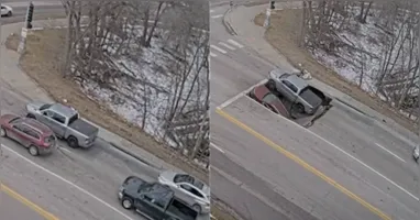 As imagens mostram uma picape e um SUV parados em um semáforo quando parte da pista cede.
