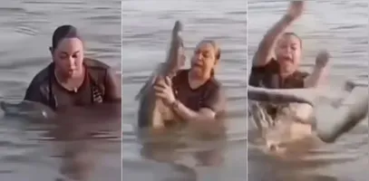 Mulher segura 'pedaço de tronco' em lagoa e descobre ser um jacaré.