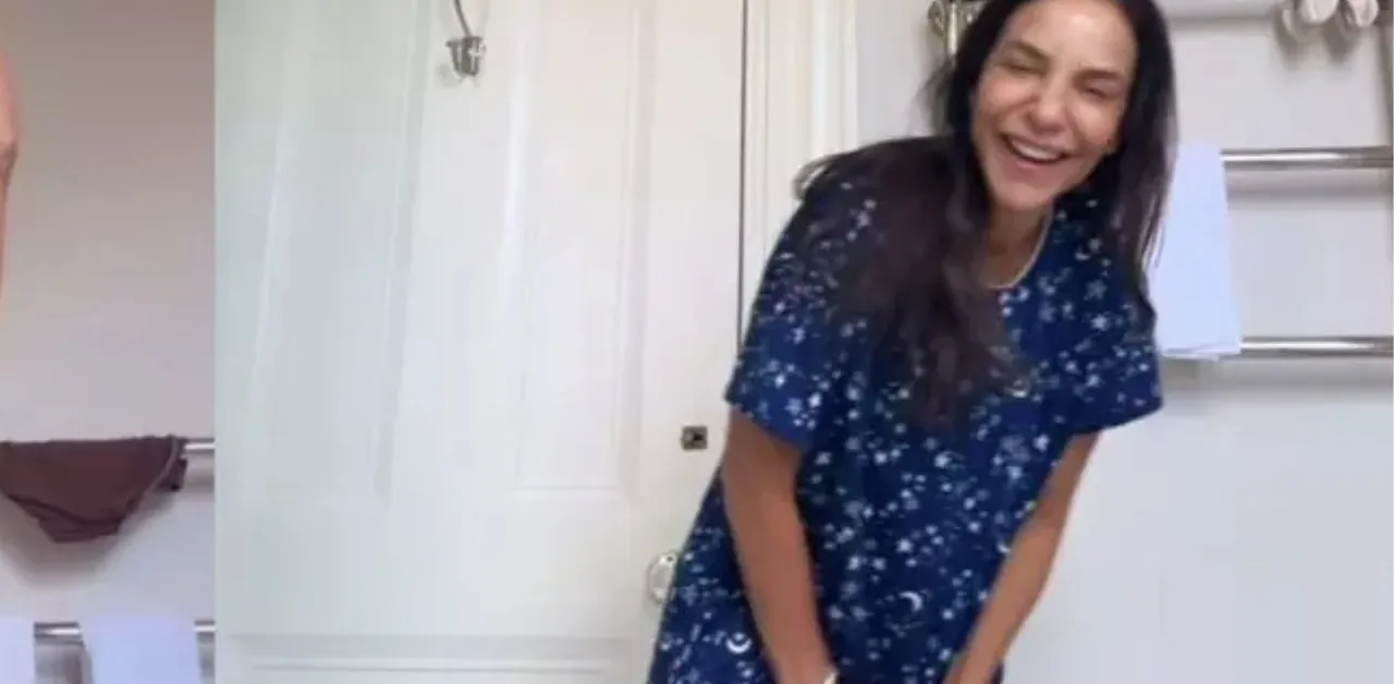 Sempre carismática, a cantora surgiu usando uma camisola azul estampada, enquanto dançava