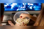 Pipoca pronta, controle na mão e luz apagada: o combo perfeito para a noite de domingo.