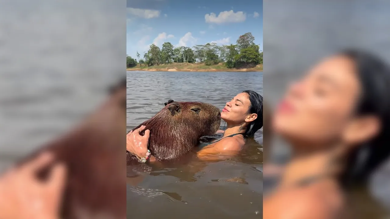 A influenciadora paraense Lia Mendonça viralizou ao compartilhar momentos de carinho com uma capivara, incluindo abraço, mergulho e até um "selinho".