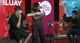 Nas imagens que circulam na internet, ela aparece ao lado do artista e começa a cantar uma frase que rapidamente virou meme: “O que tem no carro?”