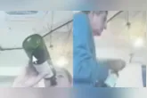 Juiz Milton Lívio Lemos Salles aparece de bermuda, bebendo vinho diretamente de uma garrafa e fumando durante sessão de julgamento por videoconferência.