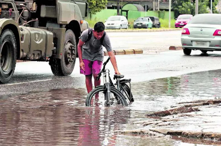 Outro ciclista enfrenta dificuldade por causa do alagamento