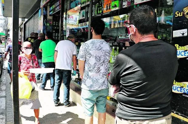 Lojistas organizavam filas para que clientes entrassem para fazer as compras

