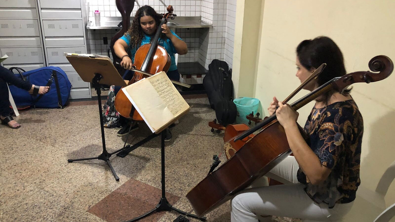 Aluna do Programa Vale Música Belém tomando aula de violoncelo.