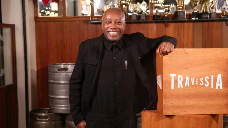 Em "Travessia", Nando Cunha (Joel) vive o garçom de um bar tradicional do bairro de Vila Isabel.