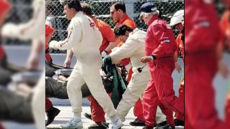 Dr. Misley, de macacão creme, à direita com a cabeça curvada, após o acidente de Ayrton